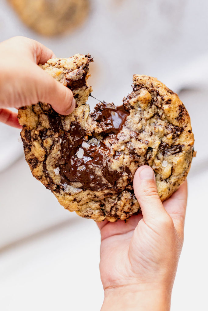 Buttery, chocolate chunk cookies with crisp edges, soft centers filled with melty dark chocolate & a sprinkle of flaky sea salt.